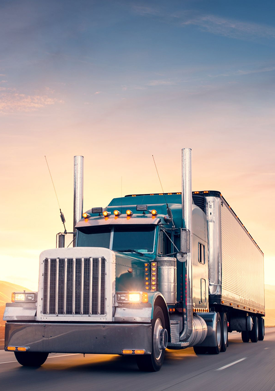 TMC truck on the highway at sunset