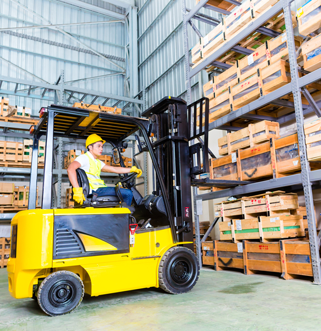 Forklift operator moving crates in a warehouse