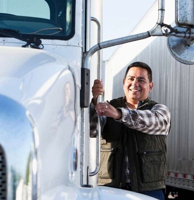Driver climbing into his truck cab