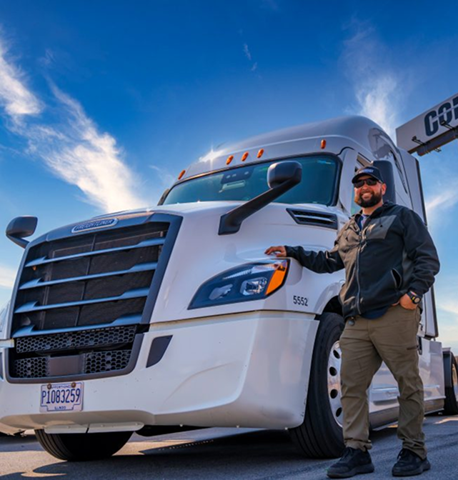TMC driver beside his truck